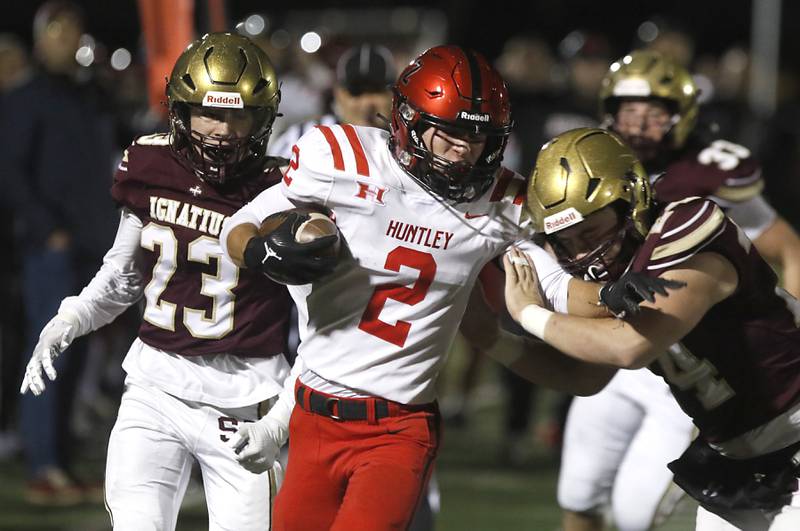 Huntley's Zack Garifo runs wit the ball as si24\ tries to tackle him during a IHSA Class 8A second round playoff football game on Friday, Nov. 3, 2023, at St. Ignatius College Prep in Chicago.