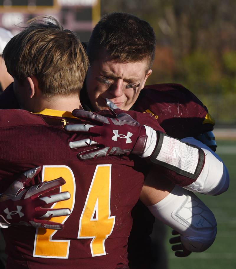 Joe Lewnard/jlewnard@dailyherald.com
Montini's Jaxon Lane, right, hugs teammate George Asay after the Broncos lost to Byron 26-20 during the Class 3A semifinal game in Lombard Saturday.