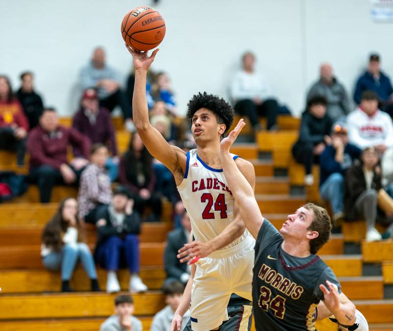 Marmion’s Trevon Roots (24) shoots the ball in the post against Morris’ Ashton Yard (24) during the 59th Annual Plano Christmas Classic basketball tournament at Plano High School on Tuesday, Dec 27, 2022.