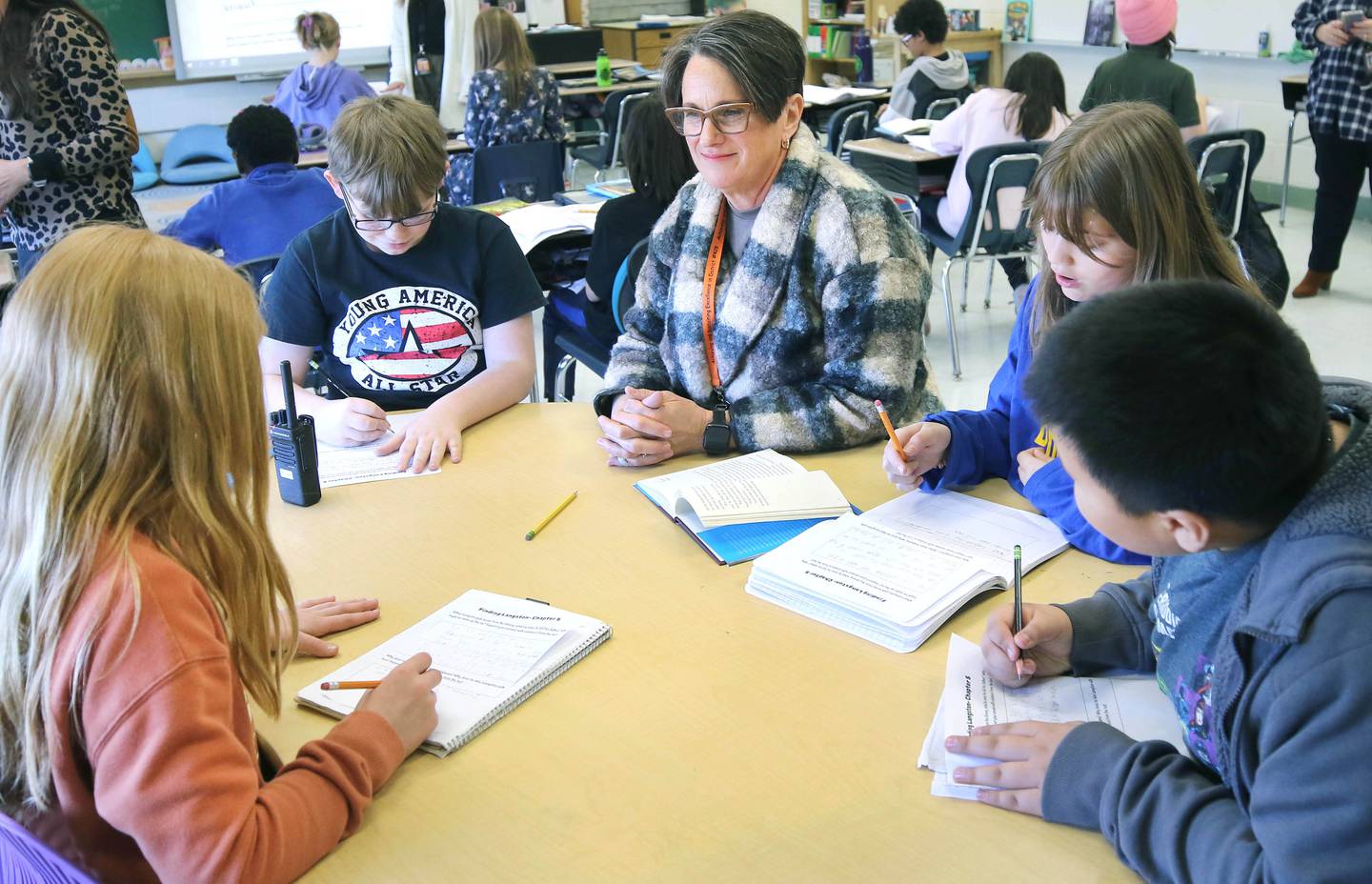 Mary Lynn Buckner, longtime educator at Littlejohn Elementary School, supports Nicole Schmidt's fifth-grade class during their individual work time Tuesday, March 14, 2023, at the school in DeKalb.