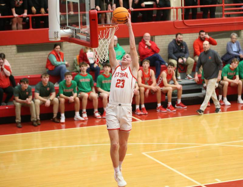 Ottawa's Owen Sanders dunks the ball on a breakaway against L-P on Friday, Jan. 10, 2024 in Kingman Gym at Ottawa High School.