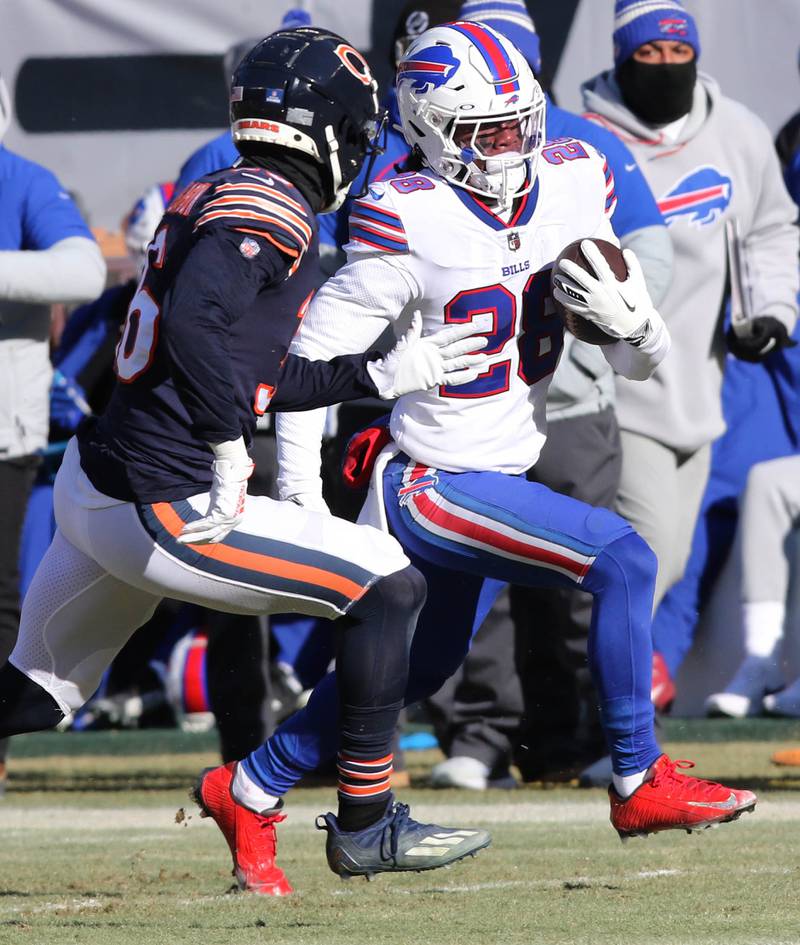 Buffalo Bills running back James Cook is pursued by Chicago Bears safety DeAndre Houston-Carson during their game Sunday, Dec. 24, 2022, at Soldier Field in Chicago.