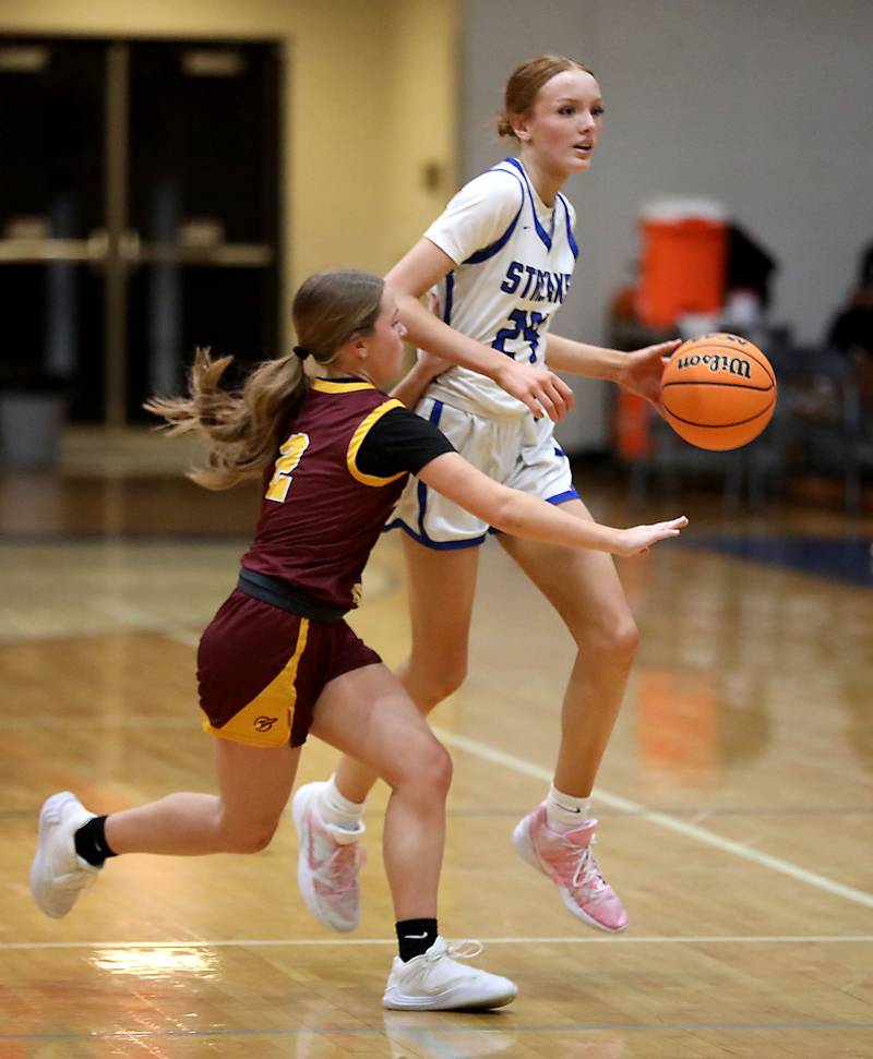 Woodstock's Aiyana Fourdyce brings the ball up the cart against Richmond-Burton's Cambrie Lindholm during a Kishwaukee River Conference girls basketball game on Wednesday, Jan. 28, 2026, at Woodstock High School.