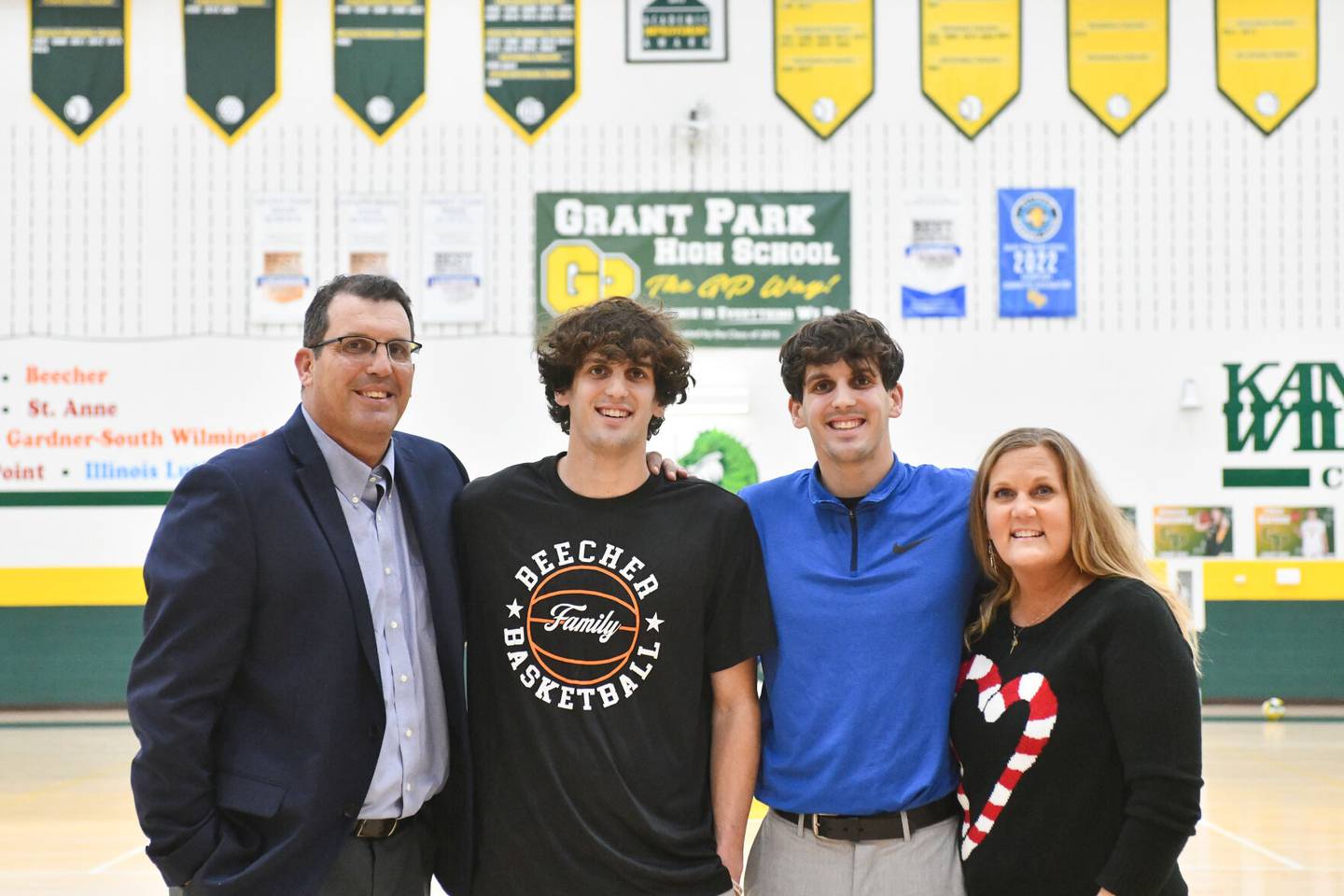 Grant Park school district Superintendent John Palan, left, and his wife and longtime district teacher Lee Ellen, right, stand with their sons Daniel, left center, and David, in the gym at Grant Park High School where the twins graduated from in 2019. Both Daniel, now a teacher and coach in the Beecher School District, and David, a teacher and coach in the Central School District, followed in their parents footsteps of making an impact on area youth through education.