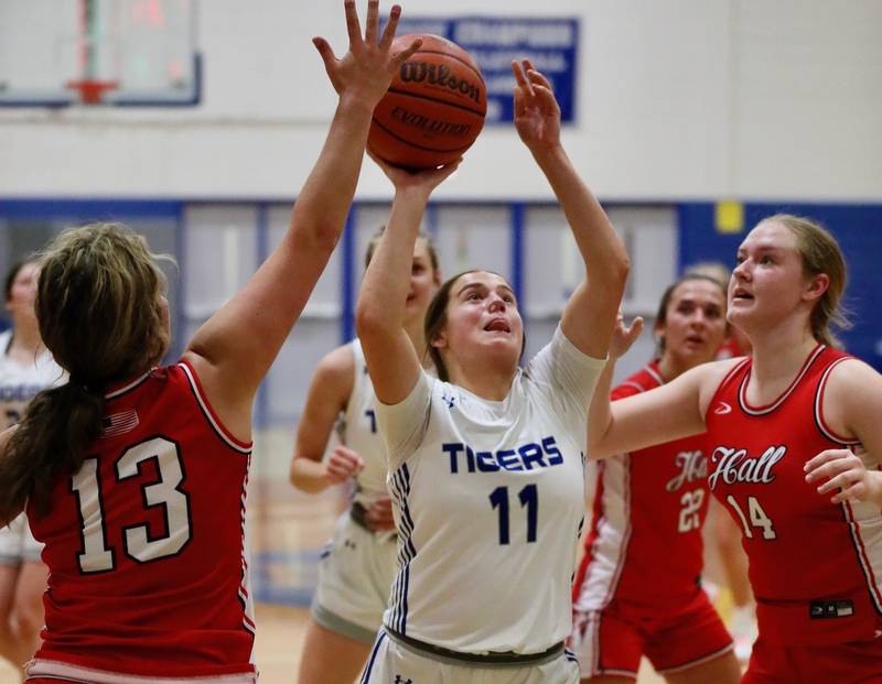 Princeton's Mikayla Hecht shoots between Hall's McKenna Christiansen and Ella Sterling Thursday night at Prouty Gym. The Tigresses moved into first place in the TRA East with a 57-38 win.