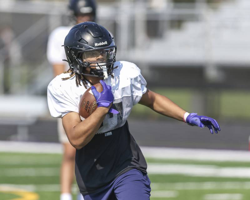 Kevin Jay runs with the ball at Downers Grove North High School football practice, Thursday, Aug 14, 2025  in Downers Grove.