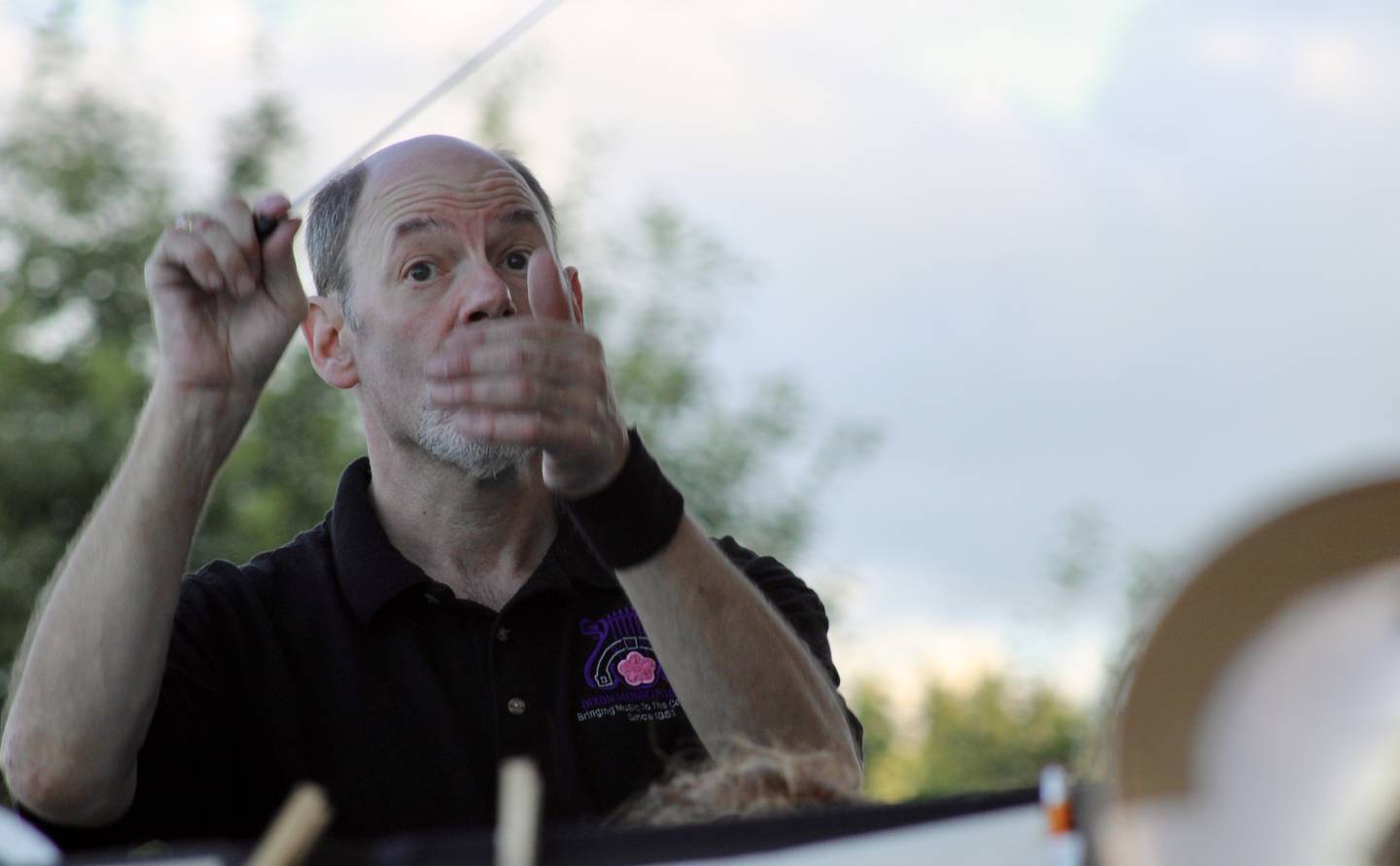 Conductor Jon James focuses his attention on the french horn soloist during the playing of the "Emperata Overture" on by the Dixon Municipal Band on Thursday at Page Park in Dixon.
