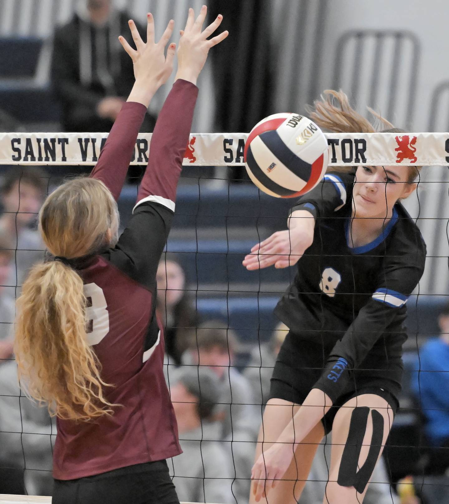Burlington Central’s Ainsley Wilson gets her shot past Wheaton Academy’s Abby Schroeder in an IHSA Class 3A sectional semifinal girls volleyball game in Arlington Heights on Tuesday, Nov. 5, 2024.