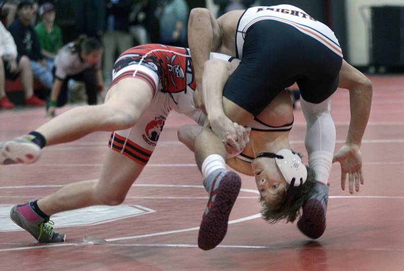 Ottawa’s Malachi Snyder works to lift up and bring down Kaneland’s Josh Karther in the 144# match Thursday at Ottawa.