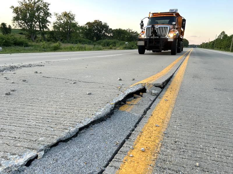 An Illinois Department of Transportation truck blocks traffic from a pavement blowout on Illinois Route 2 at Townline Road, south of Byron, Tuesday evening, July 1, 2025. The state highway was closed between Oregon and Byron as crews patched the roadway. There was another blowout south of this one, just north of Silver Ridge Golf Course.