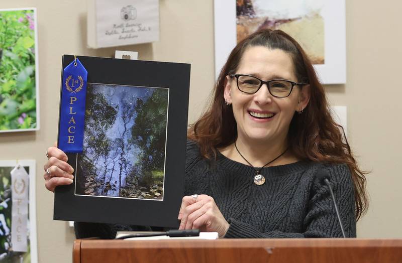 Sabrina Ory of Peru, smiles while holding her first place photo in the landscape catagory during the Starved Rock Photography Show awards on Saturday, Jan. 3, 2026 at the Starved Rock Visitors Center.