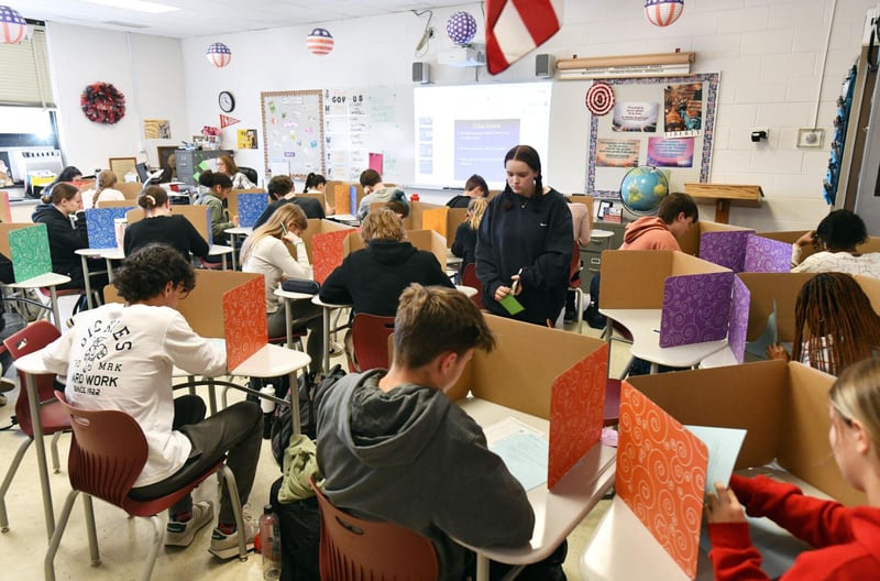 A student maneuvers through desks to turn in a test in March in Mrs. Laurie Januski’s class at Bradley-Bourbonnais Community High School. BBCHS recently announced that 49 of its senior students were named Illinois State Scholars.