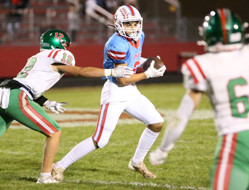 Ottawa's Andrew Vercolio fights to get away from L-P's Rylynd Rynkewicz and teammate Adrian Arzola on Friday, Oct. 4, 2024 at King Field.