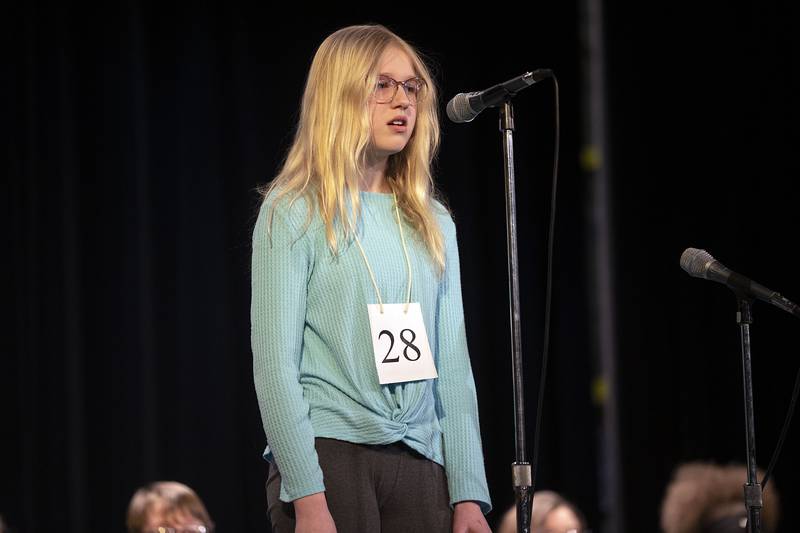 St. Paul Lutheran sixth grader Annaliese Cox appears on stage Thursday, March 9, 2023 during the Lee-Ogle-Whiteside Regional Spelling Bee.