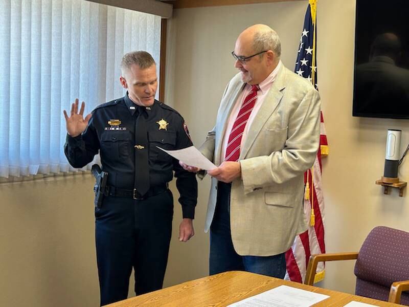 Morrison Mayor Scott Vandermyde (right) swears in new Morrison Police Chief Kevin Soenksen on Tuesday, April 30, at Morrison City Hall.