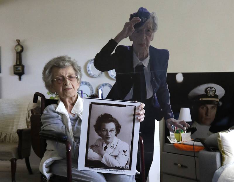 U.S. Navy veteran Lorraine Egan holds a photograph of her self from when she was in the Navy during World War II, on Monday, Oct. 30, 2023, at her home in Crystal Lake.