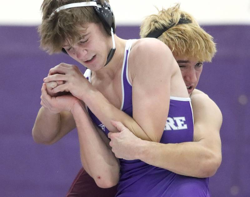 Hampshire’s William Randle-Zeglis, left, battles Prairie Ridge’s Andrew Cioper at 144 pounds in varsity wrestling on Thursday, Dec. 5, 2024 at Hampshire High School in Hampshire.