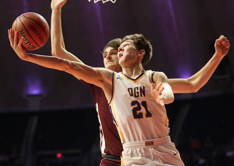 Downers Grove North's Jack Stanton lunges inside of Moline's Owen Freeman to score during the Class 4A state semifinal game on Friday, March 10, 2023 in Champaign.