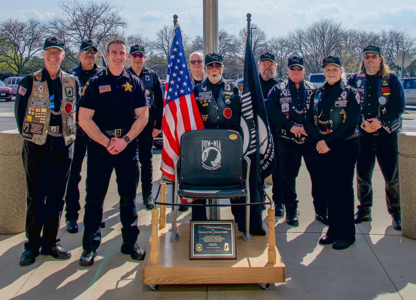 Sheriff Robb Tadelman, third from left, and members of the Rolling Thunder group are seen April 24, 2025, during the dedication of the chair in honor of POW and MIA service members. The group donated the chair, which is on display at the McHenry County courthouse.