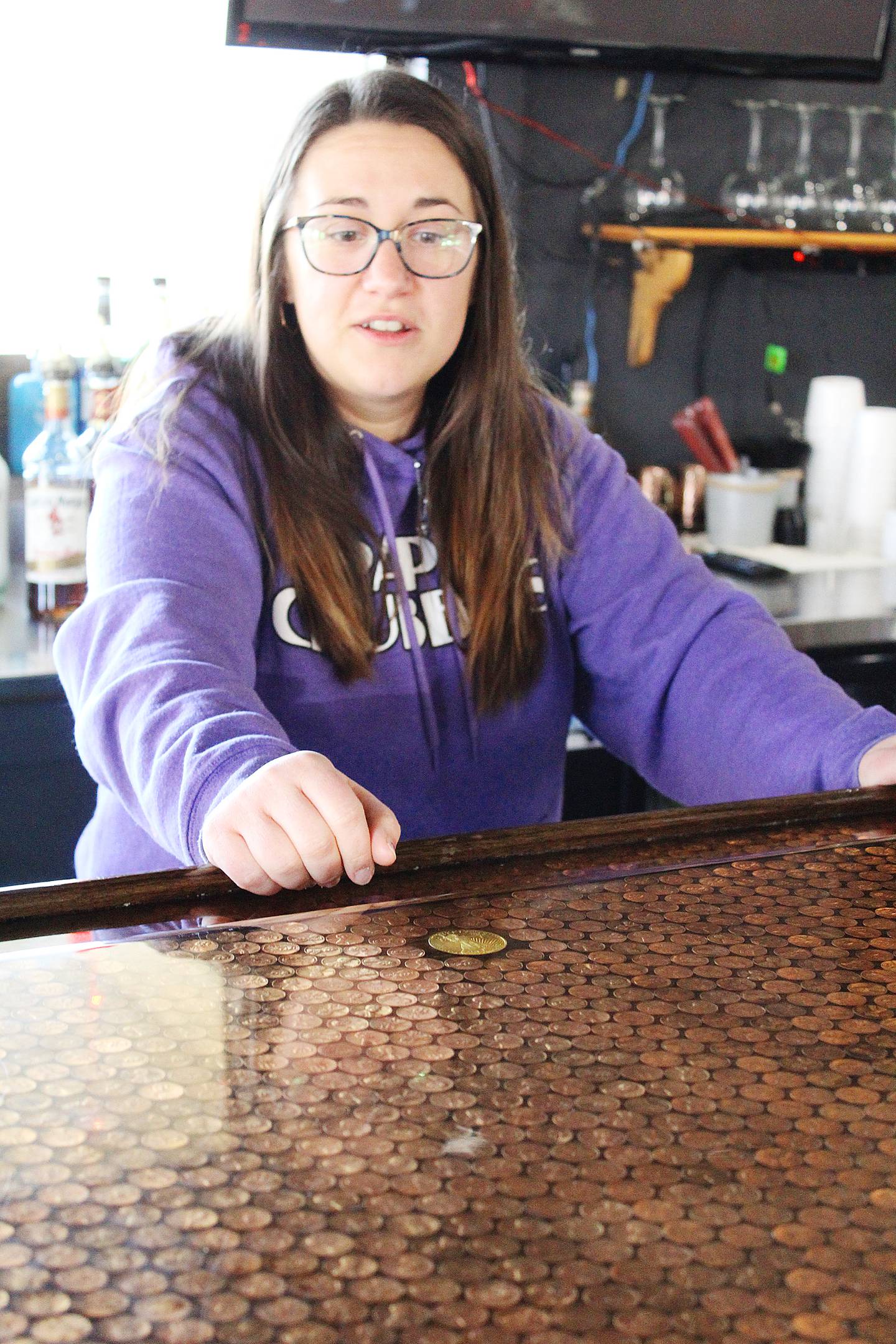 Alleigh McGinnis of Papa Chubby's shows off the penny-designed bar counter. The bar contains about $30 worth of pennies, including several Canadian coins and wheat pennies. Only a handful are flipped to tails, and most are laid heads-up. "It's something for them to do when it's a little slower," said McGinnis, daughter of Papa Chubby's owner Scott Miller. "That makes them want to come back and bring their friends and family to come check this out."