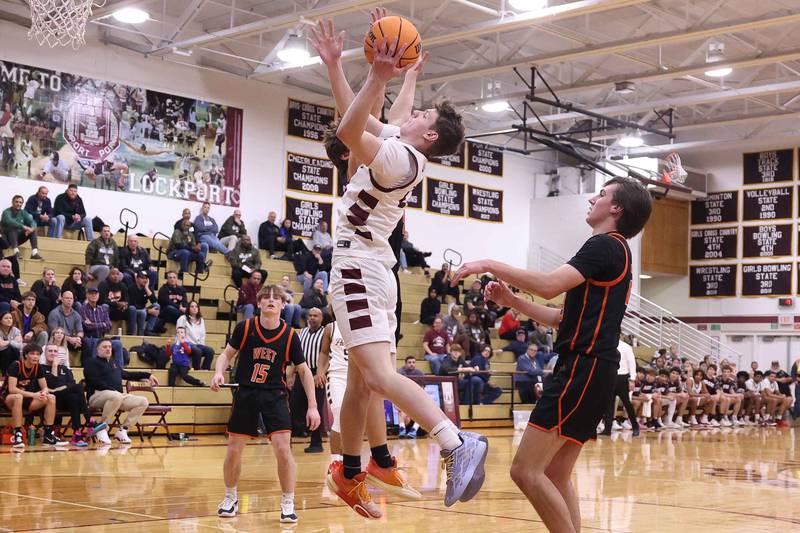 Lockport’s Collin Miller takes the contested shot against Lincoln-Way West on Friday, Dec. 6, 2024 in Lockport.