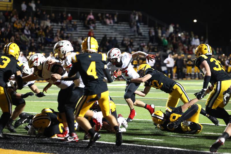 Bradley-Bourbonnais' Isaac Allison is held back on a run near the end zone by St. Laurence's Andrew Sell during the Vikings 35-21 victory over Bradley-Bourbonnais in second round playoff on Friday, Nov. 7, 2025.