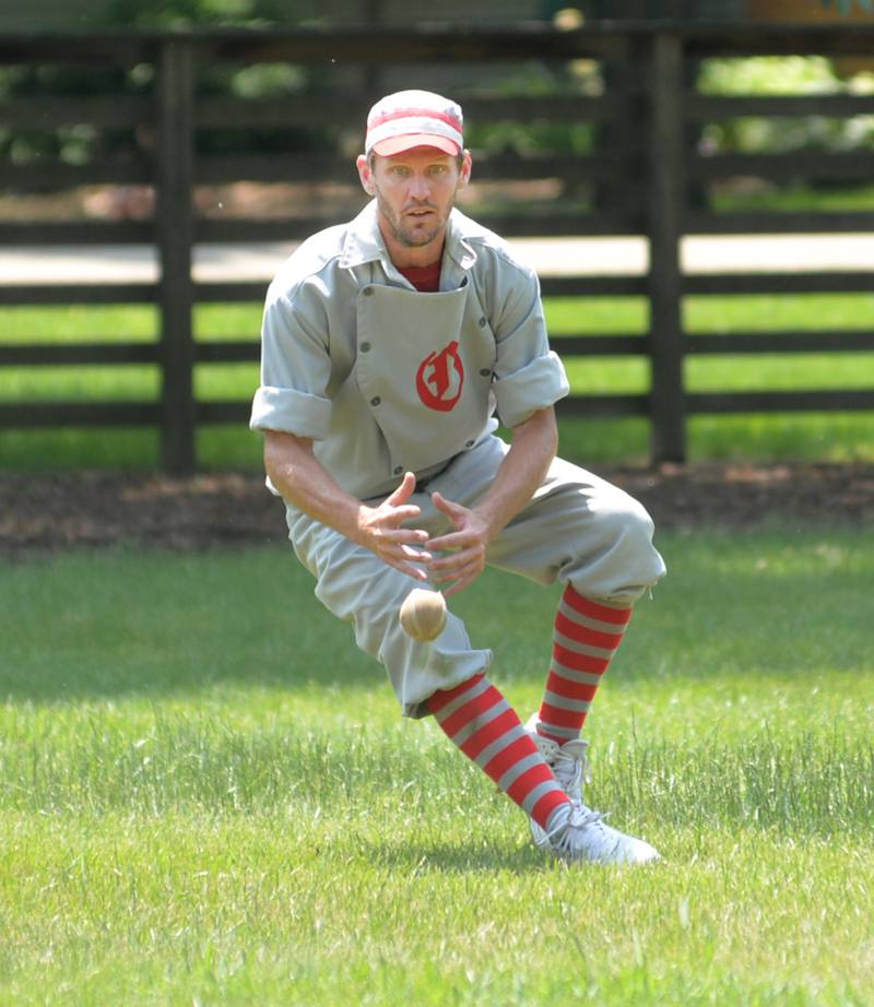 Brett "Shifty" Rogers fields a ground ball  for the Oregon Ganymedes Vintage Base Ball team during a game with the DuPage Plowboys on Saturday, June 3 at the John Deere Historic Site in Grand Detour. The game was played with 1858 rules which included no mitts, no called strikes or balls, and cloth bases. A crowd of around 200 people watched the 9-inning game 90-degree temperatures.