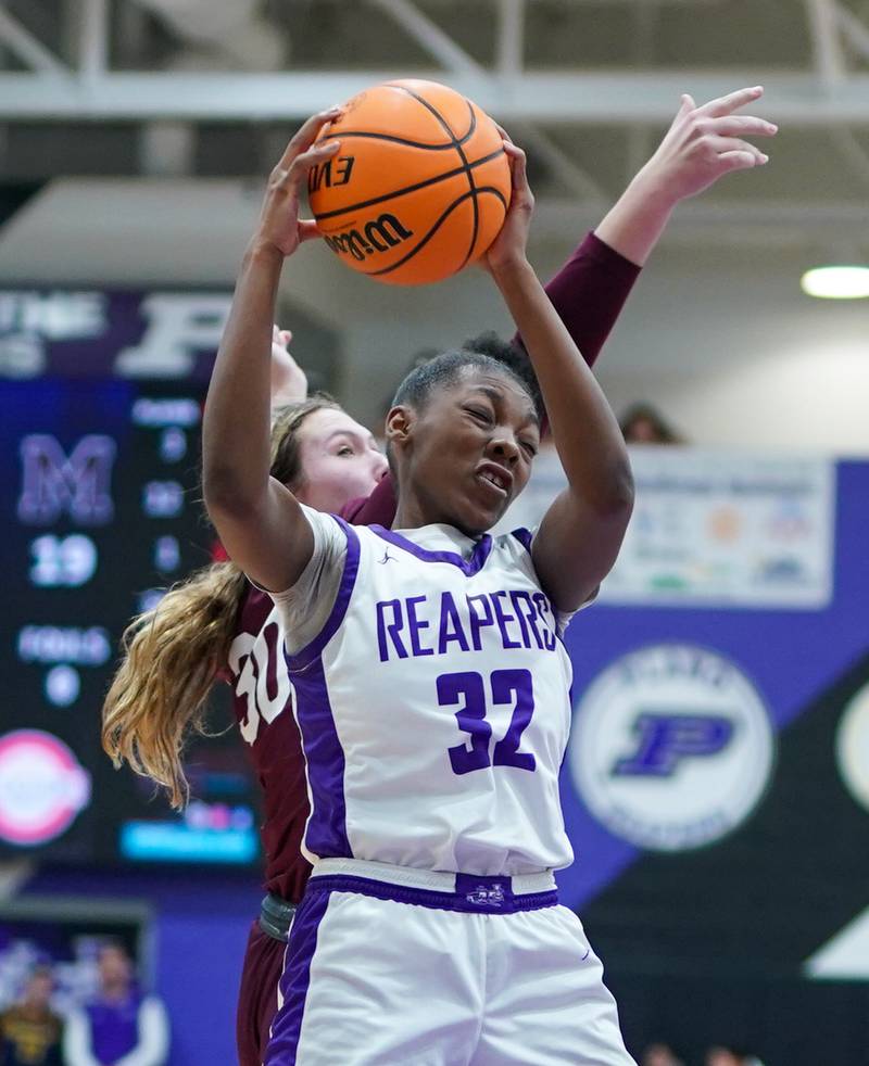 Plano's Naylah Mathews (32) rebound the ball against Marengo’s Macy Noe (30) during a basketball game at Plano High School on Wednesday, January 29, 2025.