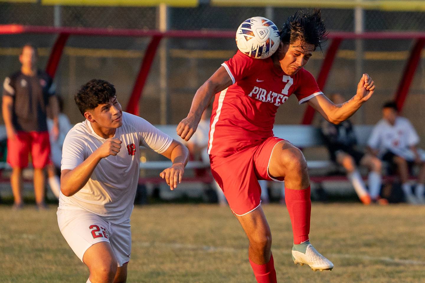 (from left) Damian Cortes (22) of L-P watches on as Jorge Lopez (7) of Ottawa headers ball on Wednesday, Sept. 17, 2025 at Ottawa High School in Ottawa.