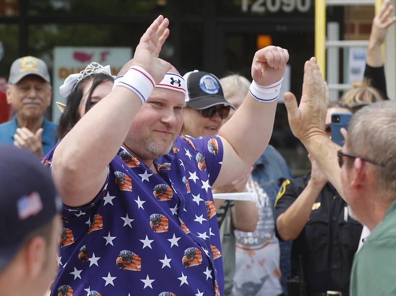 Donut eating contestant Matthew Ganek of the Huntley Police Department celebrates winning the contes at Dunkin’ Donuts, in Huntley, during the Cop on a Rooftop fundraiser to raise awareness for Special Olympics Illinois and the Law Enforcement Torch Run to benefit Special Olympics on Friday, May 19. 2023.