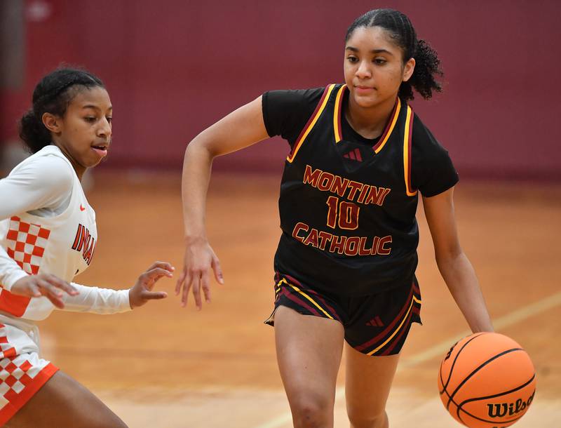 Montini’s Nathalia Richardson (10) drives as Minooka’s Kendall Thomas defends during a Montini Christmas Tournament game on December 22, 2025 at Montini Catholic High School in Lombard.
