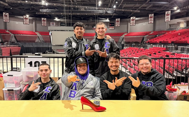 Participants pose for a photo at Safe Passage's annual Walk A Mile in Their Shoes event on April 18, 2026, at the Northern Illinois University Convocation Center in DeKalb. The event, held to raise awareness of sexual violence and supoprt survivors, was hosted by the nonprofit as part of Sexual Assault Awareness Month.
