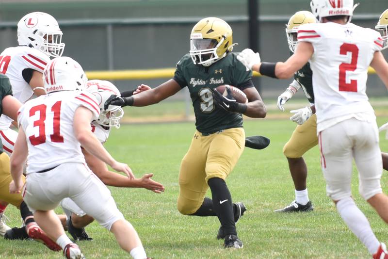 Bishop McNamara's Julius May runs through the Lawrenceville defense during a home game Saturday, Aug. 30, 2025.
