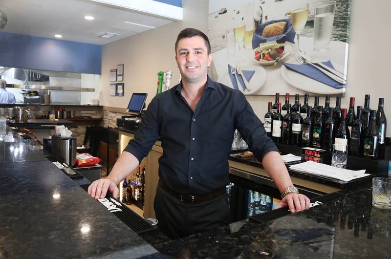 The Flame traditional Greek grill owner Foti Pappas behind the bar at the new restaurant Friday, Jan. 19, 2024, at 209 East Lincoln Highway in DeKalb.