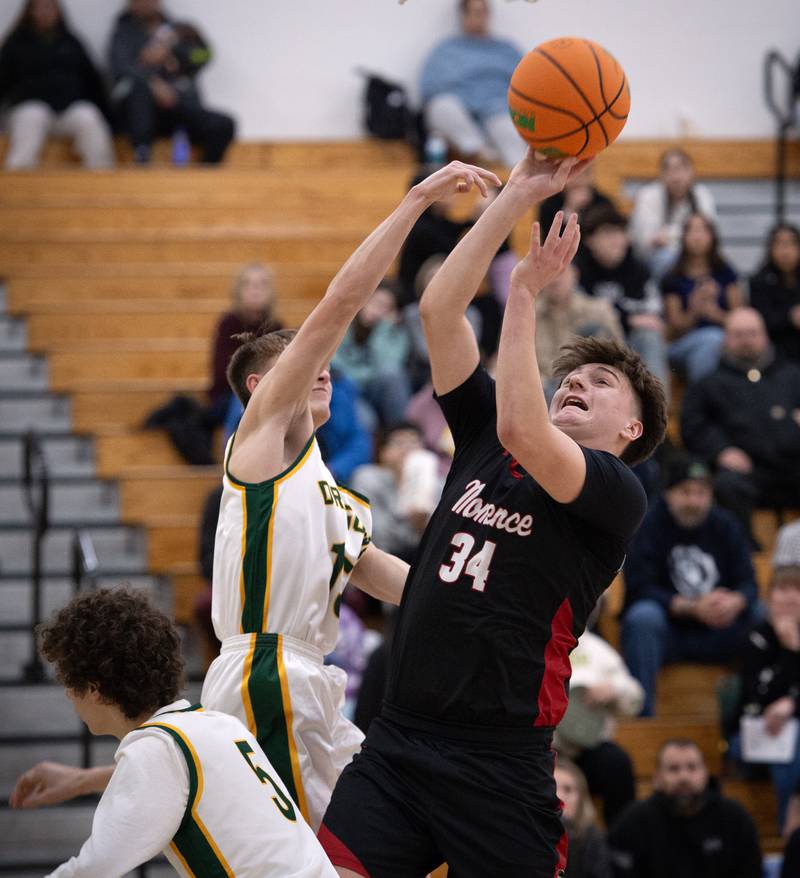 Momence's Jackson Ford elevates for a shot as Grant Park's Ian Hamann, left, guards in a game on Friday, January 16, 2026.