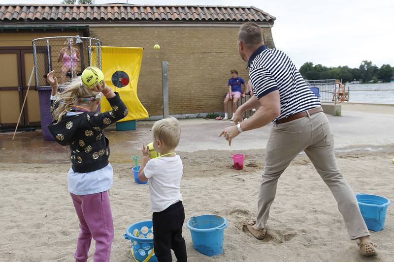 Matt Foster tosses a ball at the dunk tank as Miranda Alt during the Ice Cream Fest on Friday, Aug. 9, 2024, at Crystal Lake’s Main Beach.  The second annual event featured music, ice cream venders and an ice cream eating contest.