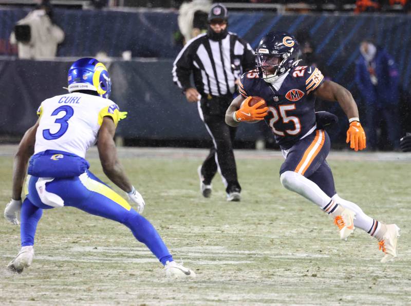 Chicago Bears running back Kyle Monangai looks to get by Los Angeles Rams safety Kam Curl Sunday, Jan. 18, 2026, during their NFC divisional playoff matchup at Soldier Field in Chicago.