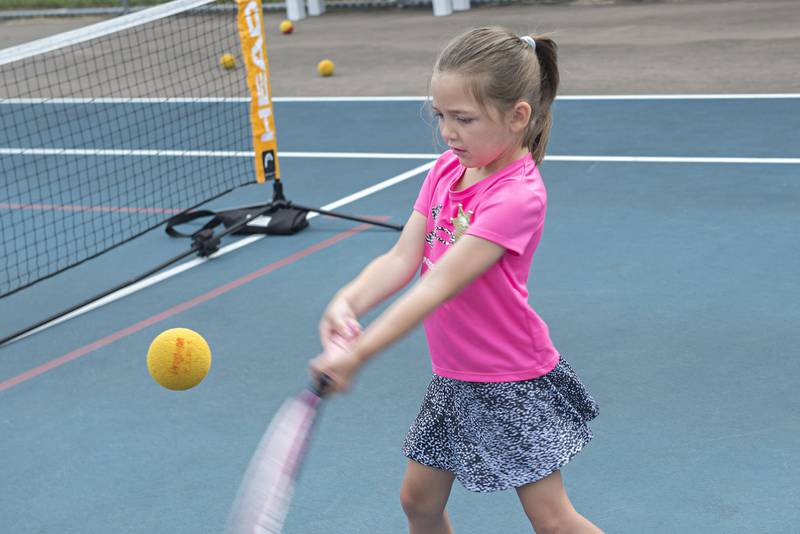 Lila Reuter plays the ball while competing in the tiny tots event at the Emma Hubbs Tennis Classic Monday, July 25, 2022.