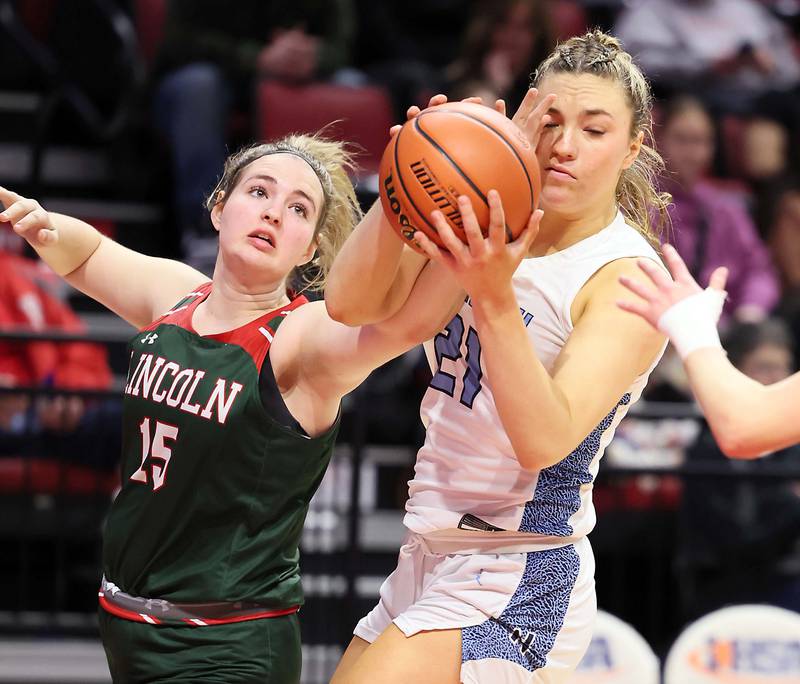 Lincoln's Piper Whiteman (15) gets a hand on Nazareth Academy's Olivia Austin (21) as she goes to the hoop during the IHSA Class 3A girls basketball championship game at the CEFCU Arena on the campus of Illinois State University Saturday March 4, 2023 in Normal.