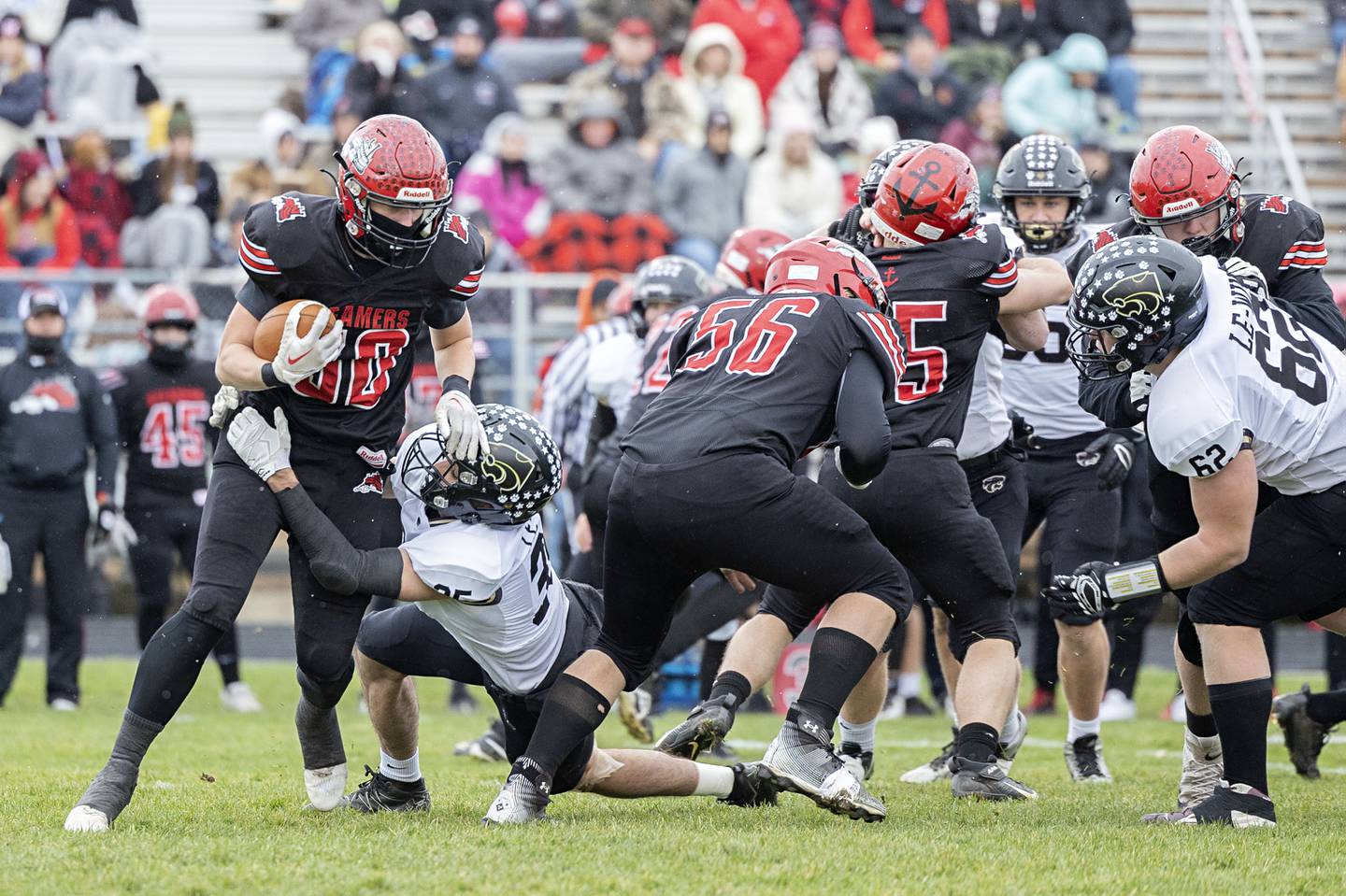 Fulton’s Lukas Schroeder is hauled down in the backfield Saturday, Nov. 12, 2022 in a quarterfinal game against Le/Win.