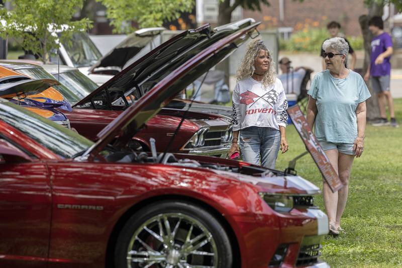 Selena Jasinski (left) and Kim Salentine, both of Dixon, walk through the Petunia Fest car show Friday, July 4, 2025, at John Dixon Park. The mother/daughter duo spent the day checking out the dozens of cherry cars at the show.