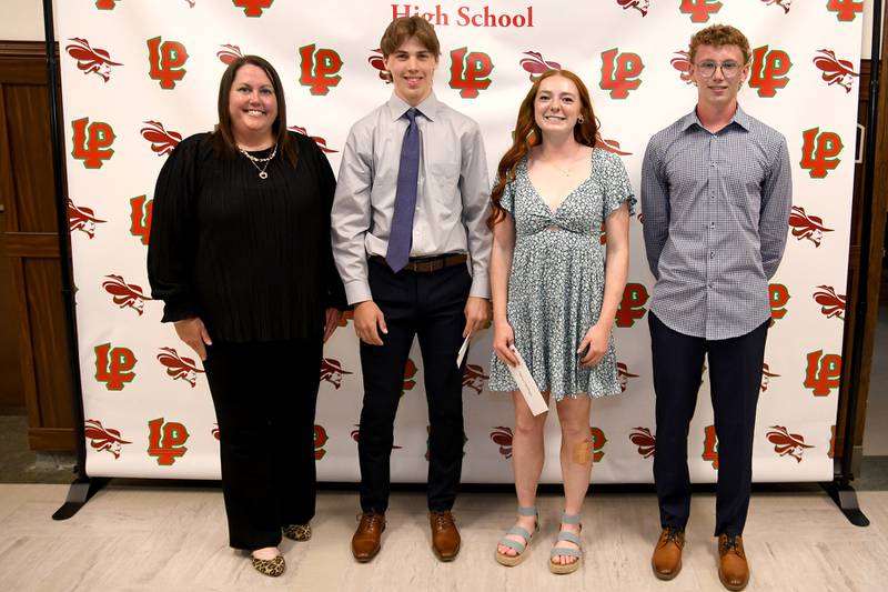 Seth Adams (starting second from left), Addison Duttlinger and Andrew Bollis received Athletic Booster Club Scholarships. The L-P Athletic Booster Club presents these $500 scholarships to L-P student-athletes who participate in at least one sport each year of high school, have a minimum GPA of 3.0, have at least one parent active in the Athletic Booster Club and who complete an essay. The recipients also have their names added to a plaque. The scholarships were presented by L-P Booster Club president Tara Backes (left).