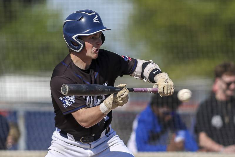 Oswego East's Caden Bregar (31) offers at a bunt during baseball game Oswego East at Oswego.  May 14, 2026 in Oswego.