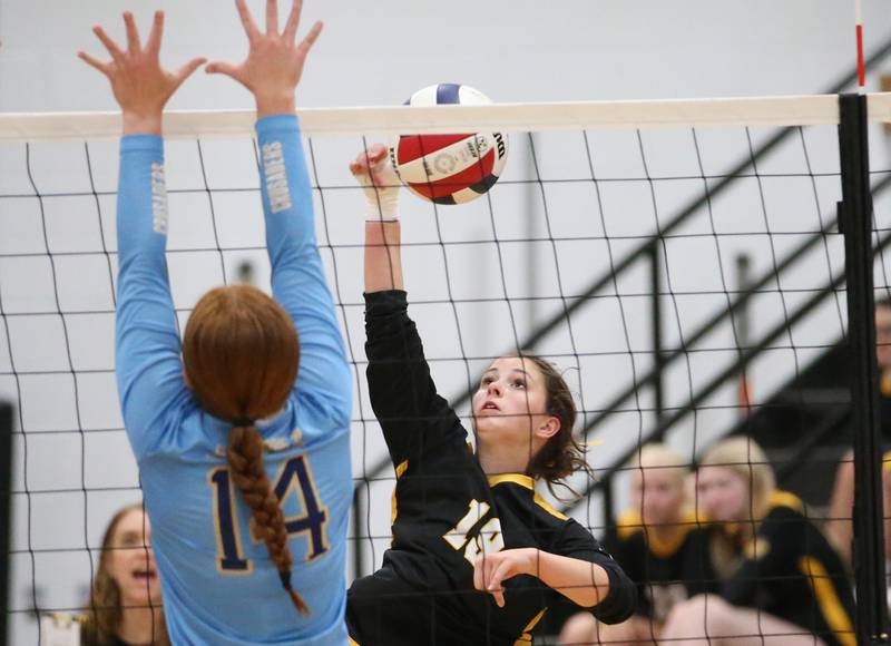 Putnam County's Avery Moutray spikes the ball past Marquette's Maera Jimenez on Thursday, Sept 7, 2023 at Putnam County High School.