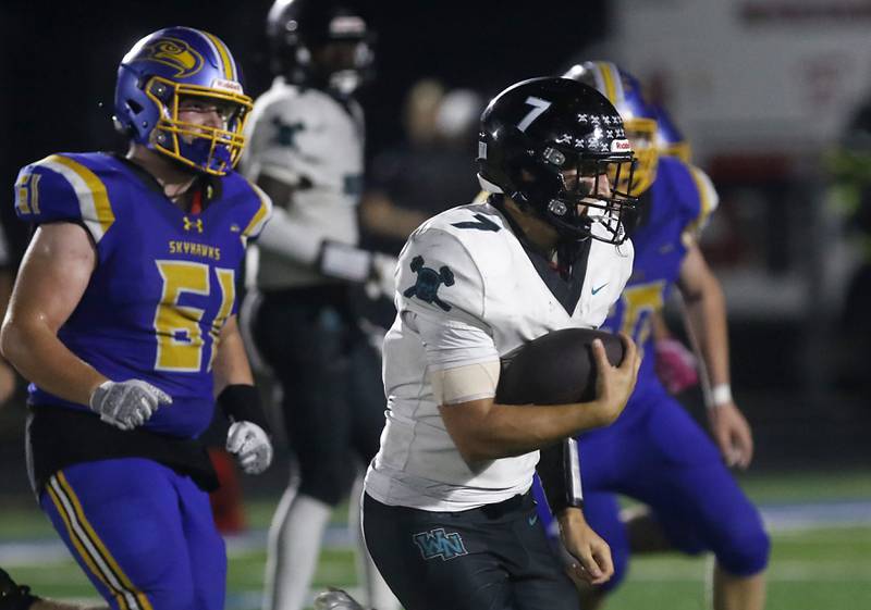 Woodstock North's Parker Halihan runs with the football during a Kishwaukee River Conference football game against Johnsburg on Friday, Sept. 26, 2025, at Johnsburg High School.