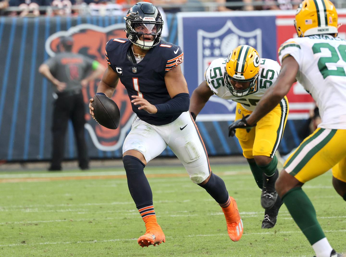 Chicago Bears quarterback Justin Fields runs away from the pass rush of Green Bay Packers linebacker Kingsley Enagbare during their game Sunday, Sept. 10, 2023, at Soldier Field in Chicago.