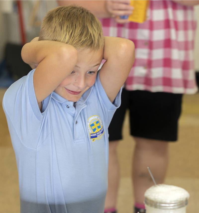 Second grader Colton Lee reacts to adding baking soda to vinegar Thursday, October 10, 2024, at St. Anne’s School in Dixon. During a STREAM event at the school, students were asked to observe and sketch their findings.
