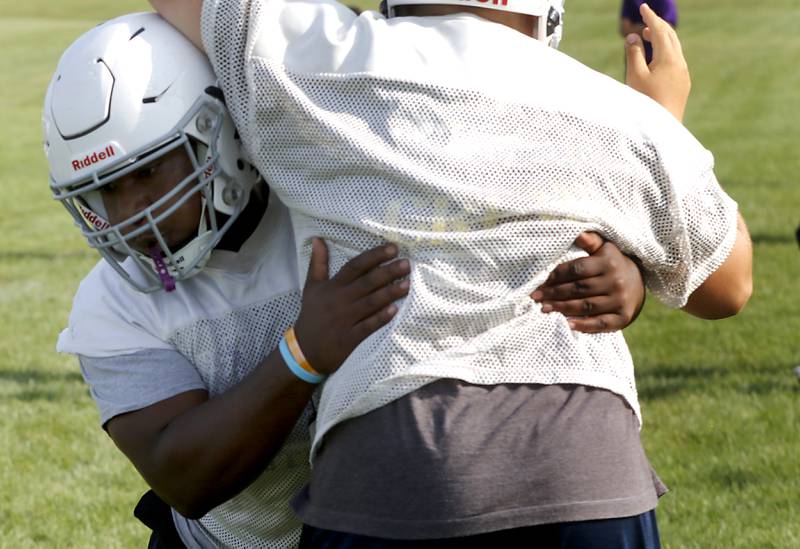Hampshire’s Chris Abihudi takes part in a tackling drill during the first day of football practice Monday, August 7, 2023, at Hampshire High School.