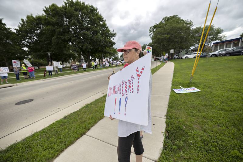 Lori Alvarez of Sterling displays a sign Thursday, July 17, 2025, during the “Good Trouble Lives On” protest in Sterling.