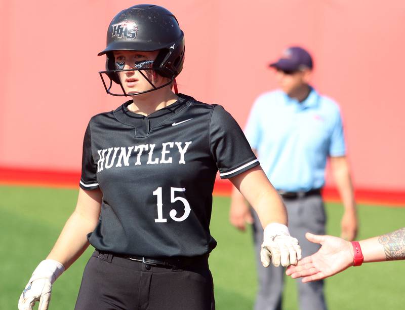 Huntley’s  Isabella Boskey is greeted as she arrives safely at first base against Barrington in IHSA Class 4A Sectional Title Game softball action at the Fields of Dreams on the campus of Barrington High School in Barrington on Friday, June 6, 2025.